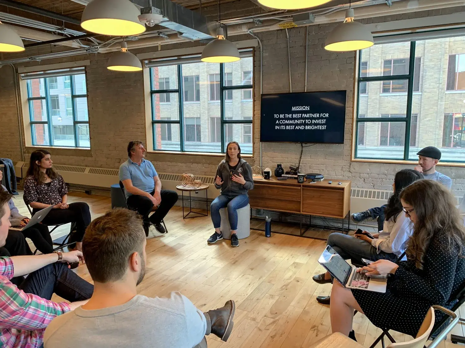 Startup founders and mentors sitting in a circle during a gener8tor accelerator program session