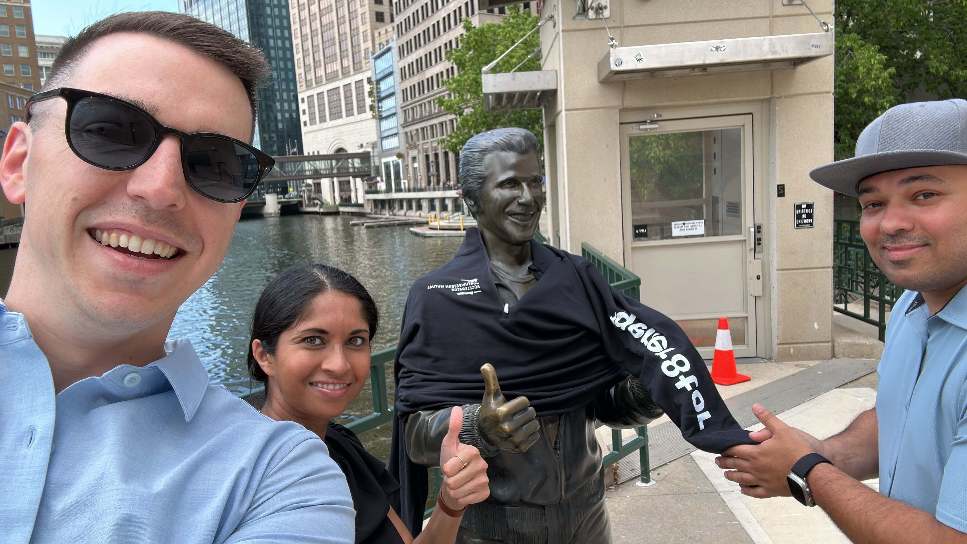 gener8tor team members smiling for a photo with a statue