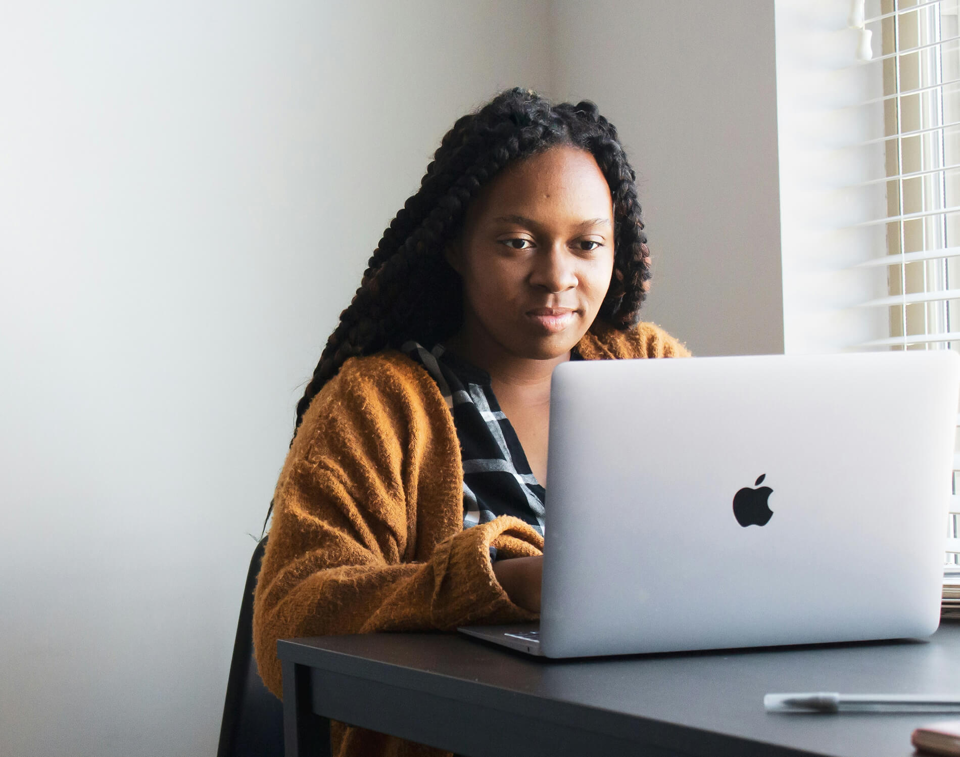Woman working on a laptop, learning AI skills