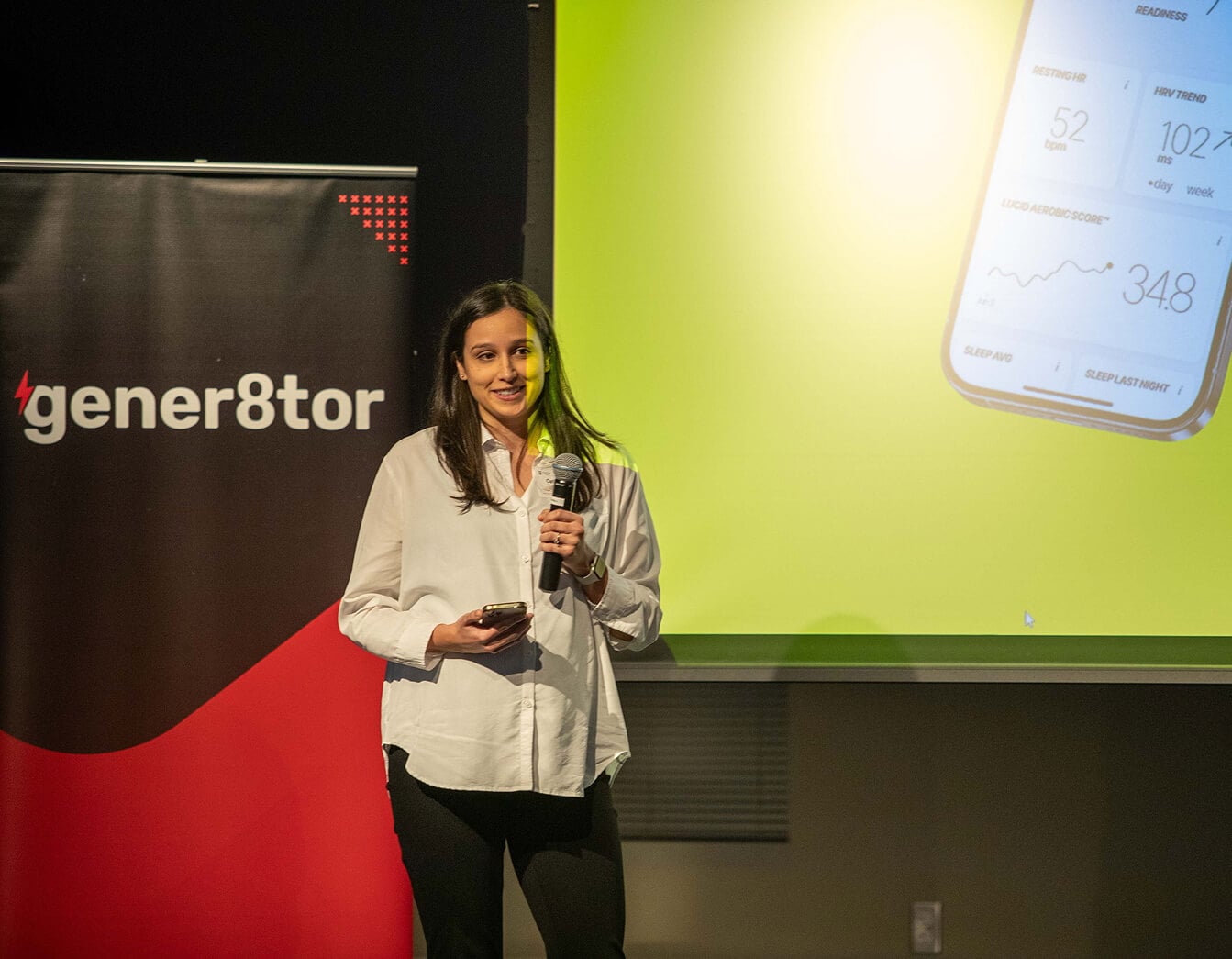 Speaker on stage at a gALPHA startup showcase