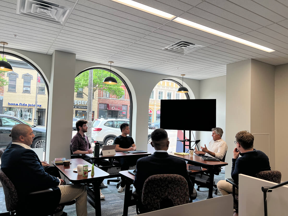 A gener8tor Wisconsin cohort sits around a table in discussion