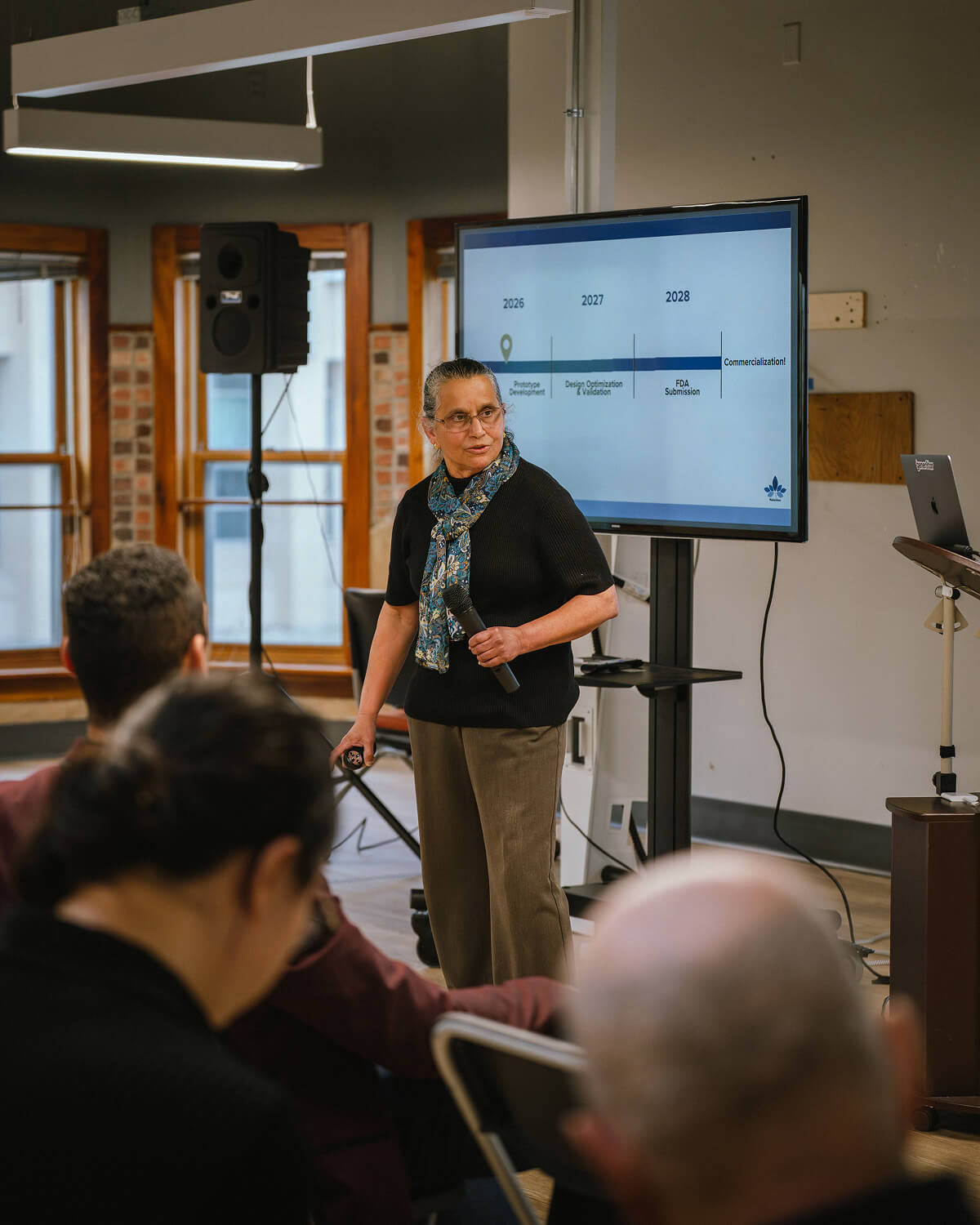 A founder presents at a screen during a gener8tor Wisconsin program